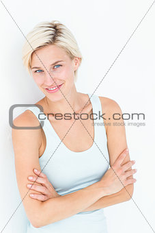 Happy woman smiling at camera with arms crossed