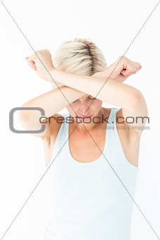 Upset woman holding her arms in front of her head