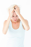 Sad blonde woman with head pain holding her head