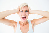 Angry blonde screaming and holding her head