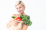 Attractive woman holding bag of vegetables