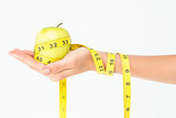 Woman holding an apple with tape measure