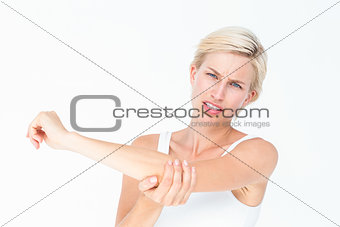 Pretty woman suffering from elbow pain