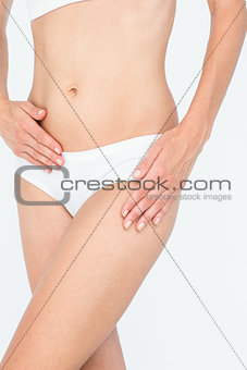 Woman touching her belly and hip