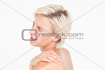 Suffering woman touching her shoulder