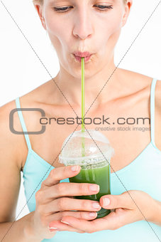 Attractive blonde drinking green juice