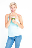 Beautiful woman drinking green juice