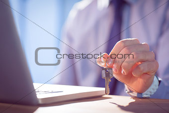 Businessman showing a key