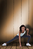 Composite image of fit woman stretching her legs