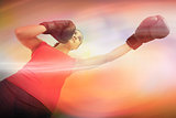 Composite image of fit woman boxing