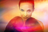 Composite image of close-up portrait of a determined female boxer
