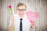 Composite image of geeky hipster holding a red rose and heart card