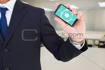 Composite image of mid section of a businessman typing on his phone
