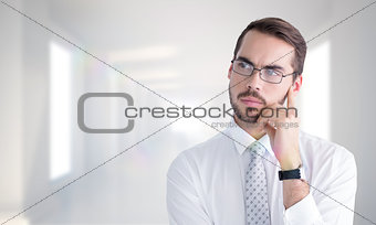 Composite image of portrait of a businessman with glasses thinking