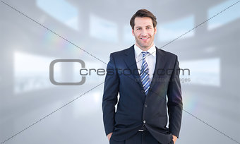 Composite image of smiling businessman standing with hands in pockets
