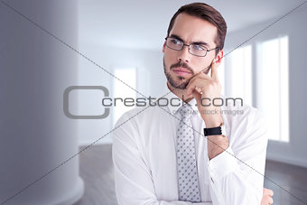 Composite image of portrait of a businessman with glasses thinking