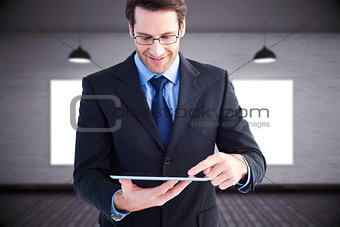 Composite image of businessman standing while using a tablet pc