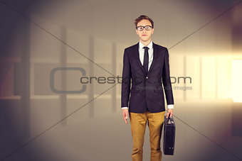 Composite image of young geeky businessman holding briefcase