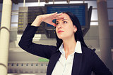 Composite image of pretty businesswoman looking with hand up