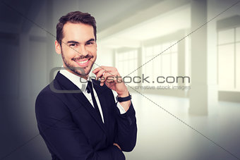Composite image of stylish businessman smiling at camera