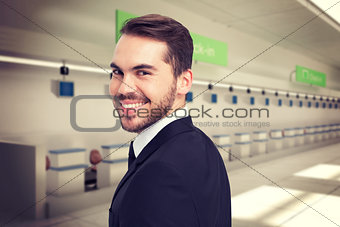 Composite image of elegant businessman in suit smiling at camera