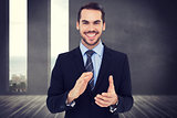 Composite image of happy businessman standing and applauding