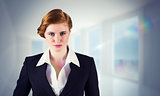 Composite image of stylish redhead businesswoman in suit