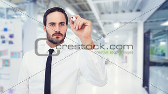 Composite image of focused businessman writing with marker