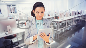 Composite image of brunette using tablet pc