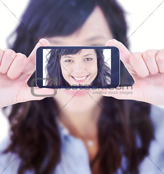 Composite image of hands holding smartphone