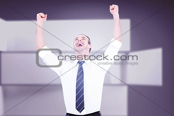 Composite image of handsome businessman cheering with arms up