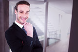 Composite image of happy businessman standing with hand on chin