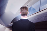 Composite image of rear view of elegant businessman in suit posing