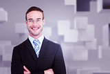 Composite image of smiling businessman in suit with arms crossed