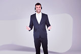 Composite image of businessman wearing headset