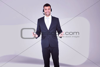 Composite image of businessman wearing headset