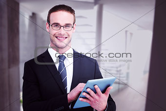 Composite image of happy businessman using his tablet pc