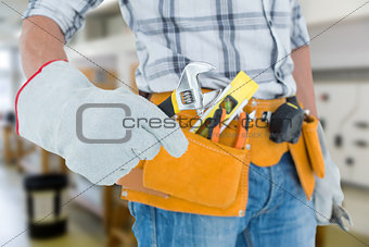 Composite image of technician using adjustable wrench against white background