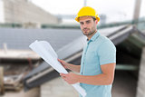 Composite image of confident male architect holding blueprint