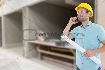Composite image of male architect with blueprint talking on mobile phone