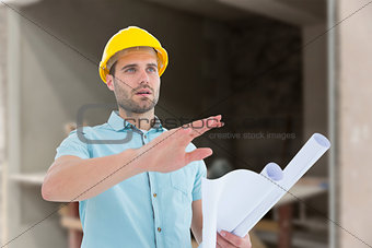 Composite image of architect with blueprint gesturing on white background