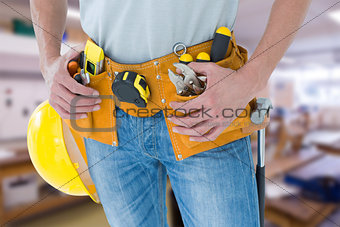 Composite image of technician with tool belt around waist