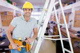 Composite image of worker holding tools while leaning on step ladder