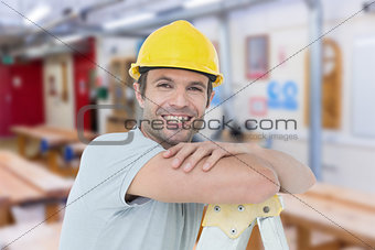 Composite image of happy technician leaning on step ladder