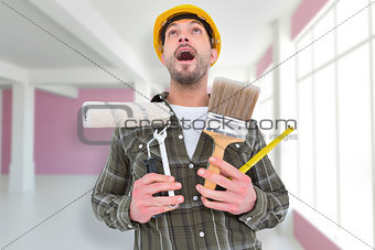 Composite image of screaming manual worker holding various tools