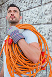 Composite image of repairman holding wire roll