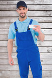 Composite image of handyman holding visiting card