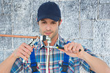 Composite image of plumber fixing pipe over white background
