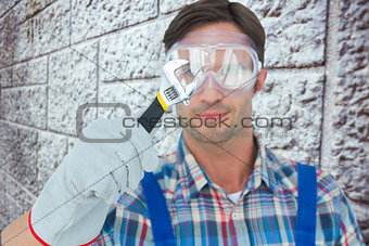 Composite image of plumber holding adjustable wrench