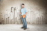 Composite image of smiling construction worker holding clipbard